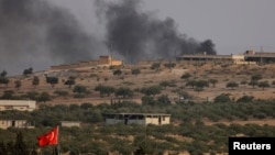 Smoke rises from the Syrian border town of Jarablus, where militant positions were attacked by Turkish forces on August 24.