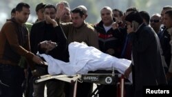 Former Egyptian President Hosni Mubarak waves to his supporters as he returns to Maadi military hospital in Cairo on November 29.