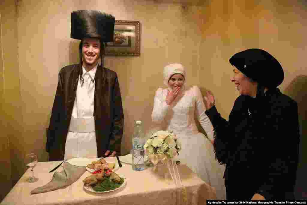 Second Place: "First Time" by Agnieszka Traczewska. Mea Shearim, Jerusalem, Israel. "Mea Shearim, Ultra-Orthodox district of Jerusalem. Newly married, Aaron and Rivkeh after the wedding ceremony are to stay together for the very first time, alone. Their marriage was arranged by families. 18 years old candidates confirmed the choice in result of the one meeting only. Since then until the wedding day they were prohibited to meet or even talk." 
