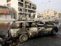 The wreckage of a car on the site of bomb attack in Baghdad on December 7 (epa)