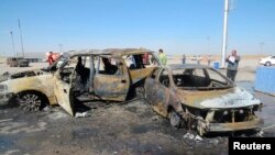 People gather at the site of a car-bomb attack in the town of Tuz Khurmatu, north of Baghdad, on May 5.