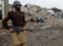 An Afghan soldier guards the site of a market destroyed in fighting between pro-Taliban militants and security forces in the tribal area of North Waziristan in early March (file photo) (epa)