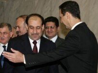 Iraq's Nuri al-Maliki met with Syria's Bashar al-Assad (right) today in Damascus (AFP)