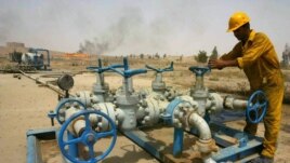 A worker checks the valves at the Kirkuk oil field.