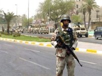 An Iraqi soldier near the site of a car bombing in Baghdad's Al-Karradah neighborhood (AFP)