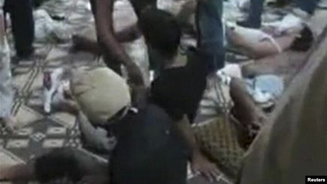 A video grab shows the bodies of people whom activists say were killed by government forces in Mazraat al-Qubeir. 