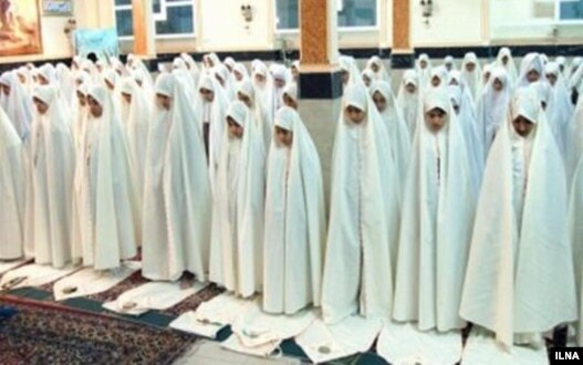 A group of Iranian student praying during school.