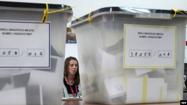 An electoral staff member waits for voters at a polling station in the ethnically divided city of Mitrovica on November 17.