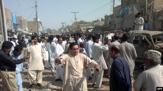 Local Pakistani residents gather at the site of a bomb blast in Sibi, some 180 kilometres southeast of Quetta. At least 10 people died in the explosion.