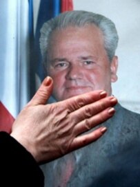 A supporter of former Serbian leader Slobodan Milosevic touches his portrait. (epa)