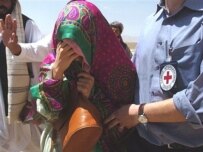 One of the three freed women is assisted by an ICRC worker (AFP)