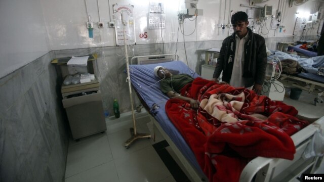 A badly injured Pakistani paramilitary soldier, who survived a shooting by Taliban militants, receives treatment at a hospital in Peshawar on December 30.