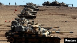 Turkish Army tanks take up position on the Turkish-Syrian border on October 6.