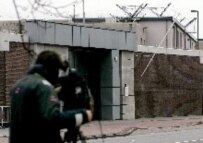 A reporter waits outside the prison in Scheveningen, The Netherlands, yesterday, where it is thought Mladic will be brought if he is arrested (epa)