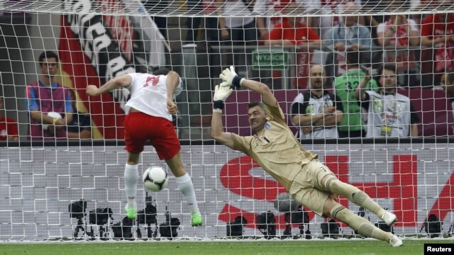 Poland's Robert Lewandowski (left) scores the first goal of Euro 2012 in the opening match against Greece. 
