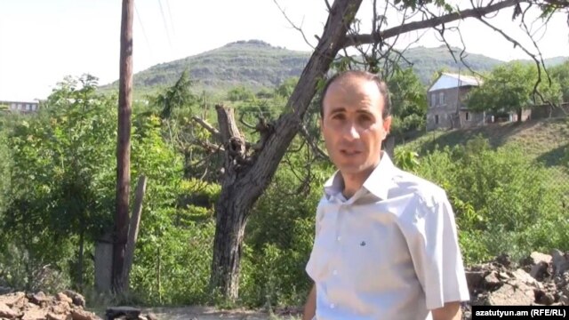 Armenia - RFE/RL correspondent Hovannes Shoghikian reports from Chinari against the backdrop of an Azerbaijani army post overlooking the Armenian border village, 8Jun2012.