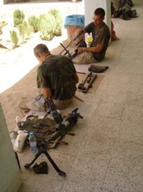 Dutch soldiers cleaning their guns at their base in Chora (RFE/RL)