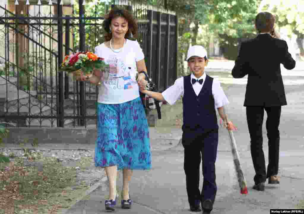 A young student sports formal wear in Almaty, Kazakhstan.