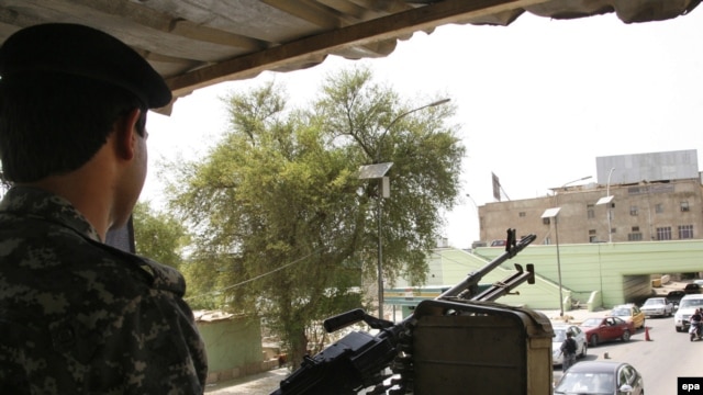 An Iraqi policeman mans a machine gun at a checkpoint in Baghdad.