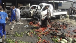 Residents inspect the site of a bomb attack in Karbala on July 3.