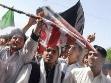 Afghanistan -- Afghan protestors burn a US flag as they shout slogans during a demonstration in Jalalabad, 02May2007