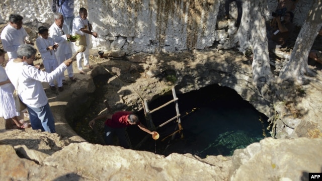 Mayan priests hold a water-blessing ceremony at the Noc Ac cenote, a natural deep deposit of water, in Yucatan, Mexico, on December 15 within the framework of a cultural festival to celebrate the end of the Mayan calendar.