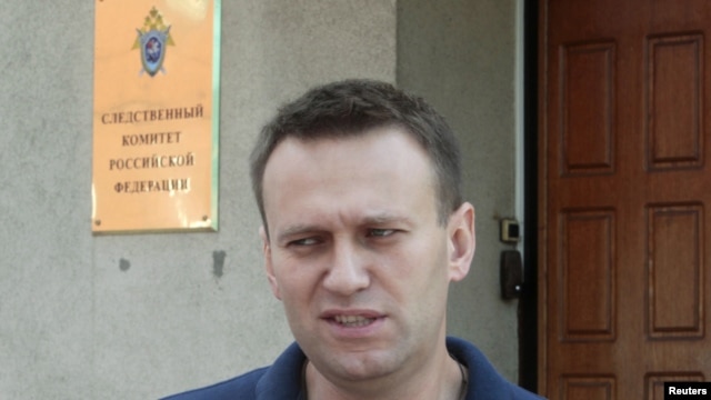 Aleksei Navalny speaks to the media outside the Federal Investigation Commission building in Moscow on June 13.