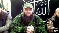 A screen grab of video posted in July 2013 shows Doku Umarov (center) at an undisclosed location.