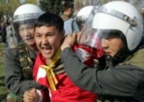 Kyrgyz police arrest a protester during demonstrations