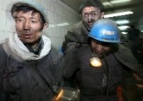 A rescue worker carries a trapped miner out of the Dongfeng Coal Mine following a blast which killed at least 134 in Qitaihe City of northeast China's Heilongjiang Province, November 2005 (epa)