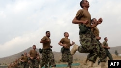 Afghan recruits run in formation at the Afghan National Army Officers' Academy in the Qargha district of Kabul on October 23.