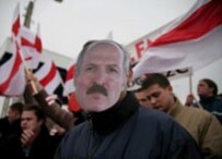 A Polish protester wears a mask of Belarusian President Alyaksandr Lukashenka at a pro-democracy demonstration at the border crossing at Kuznica (epa)
