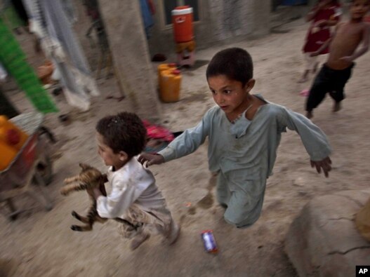 Internally displaced children play at a refugee camp in Kabul in early August.