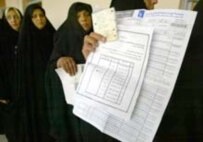 Women preparing to vote yesterday in Al-Najaf