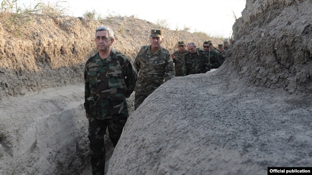 Nagorno-Karabakh - Armenian President Serzh Sarkisian walks through a frontline trench near Karabakh, 22Oct2012.