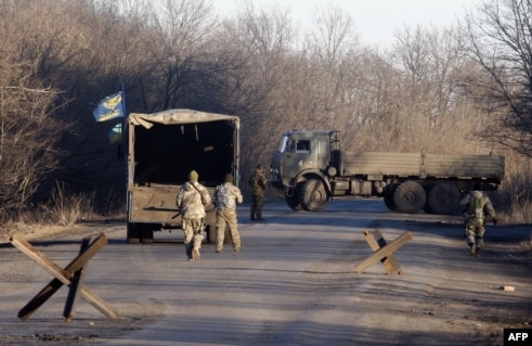 Pro-Russian rebels hand off bodies of Ukrainian soldiers killed in Debaltseve at a checkpoint near Horlivka on February 24.