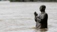 Czech Republic -- The statue of world harmony leader Sri Chinmoy is partially submerged in water from the rising Vltava river in Prague, 02Jun2013