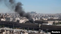 Smoke rises from the Yemen Defense Ministry's compound in Sanaa after a terrorist attack on December 5, which killed at least 52 people.