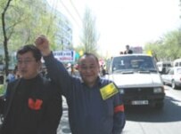 Protesters march to a rally in central Bishkek under the banner \