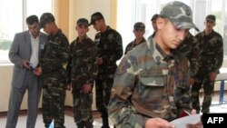 Soldiers register to vote at a polling station in Baku