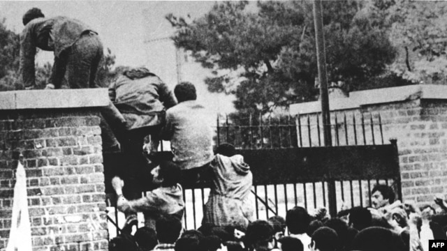 Iranian students climb over the wall of the U.S. Embassy in Tehran on November 4, 1979.