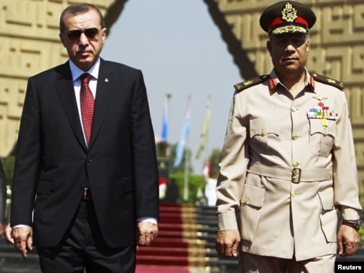 Turkish Prime Minister Recep Tayyip Erdogan (left) pays a visit to the tomb of the late former President Anwar al-Sadat's in Cairo with Egyptian army commander General Hassan al-Roweny.