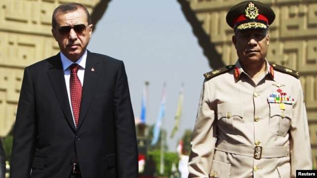 Turkish Prime Minister Recep Tayyip Erdogan (left) pays a visit to the tomb of the late former President Anwar al-Sadat's in Cairo with Egyptian army commander General Hassan al-Roweny.
