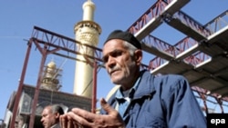 Shi'ite Muslims pray in Karbala, one of the holy cities that attracts religious tourists