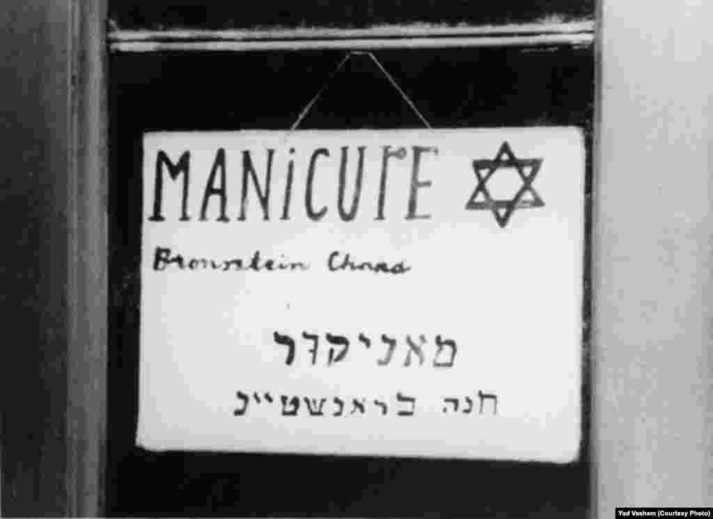 A store sign says "Manicure-Chana Branstein."