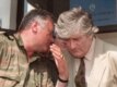 Bosnian Serb commander Ratko Mladic (left) whispers to Radovan Karadzic during a press conference in 1993