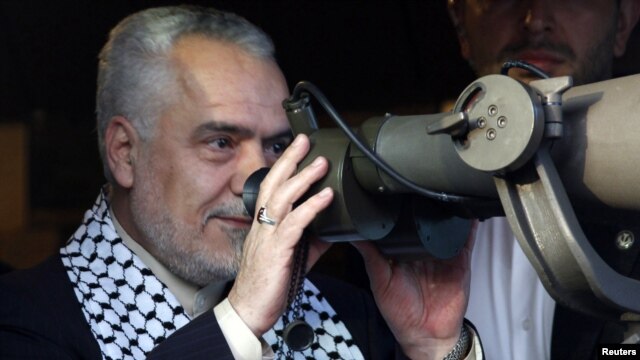 Iranian Vice President Mohammad Reza Rahimi uses a pair of binoculars as he looks toward the Israeli border from the Iranian garden of Maroun al-Ras in May.
