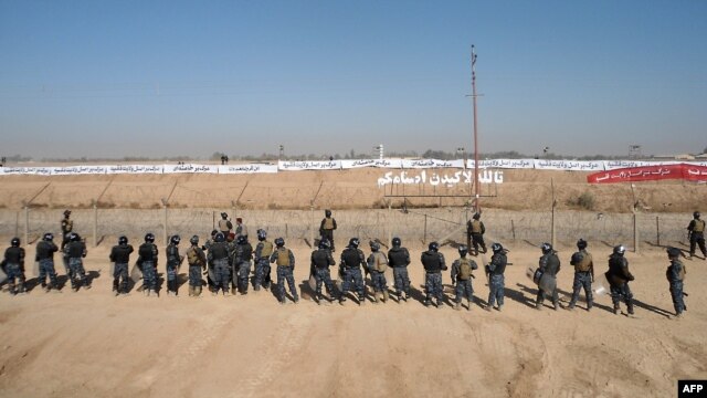 Banners against the Iranian regime are seen at Camp Ashraf, home to exiled Iranian opposition members, which is threatened with closure. 