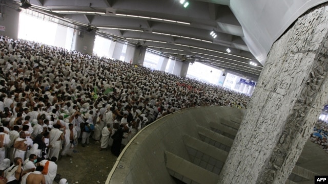 Muslim pilgrims throw pebbles at pillars during the ritual known as the stoning of Satan in Mina, near the holy city of Mecca, during the hajj.