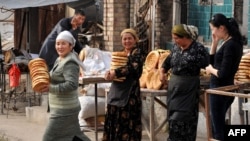Women haul bread near a street market in Osh, in southern Kyrgyzstan. (file photo)